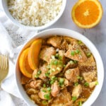 overhead shot of bowl of orange chicken and a bowl of rice