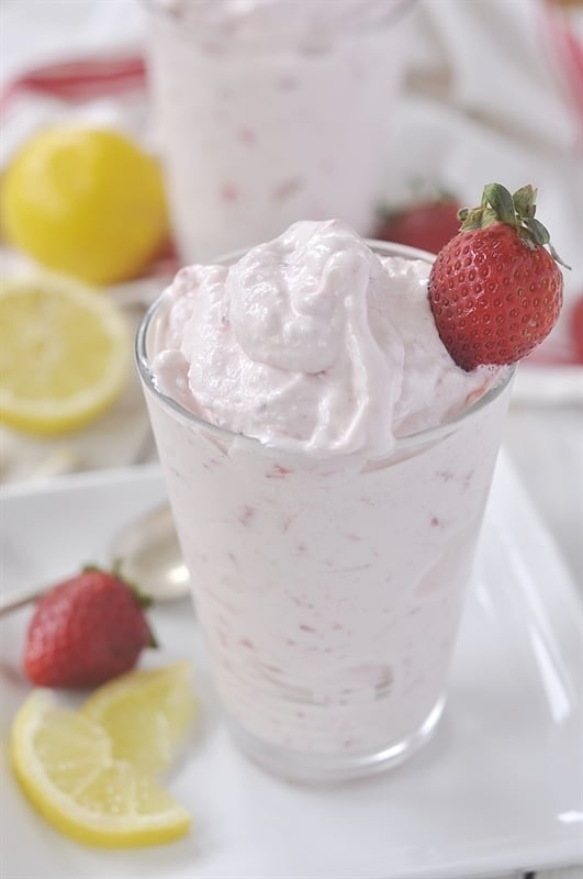 Frosted Freckled Lemonade garnished with strawberry and lemon