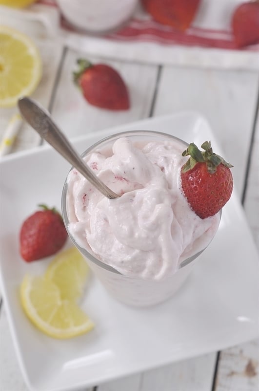 Frosted Strawberry Lemonade in a glass with a spoon