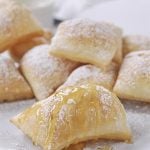 pile of pioneer scones with powdered sugar on top