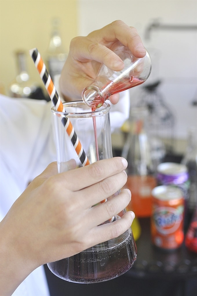 filling a beaker with soda