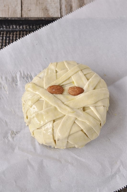 brie wrapped to look like a mummy with almond eyes