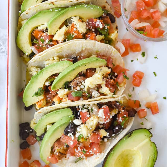 breakfast tacos on a white sheet pan