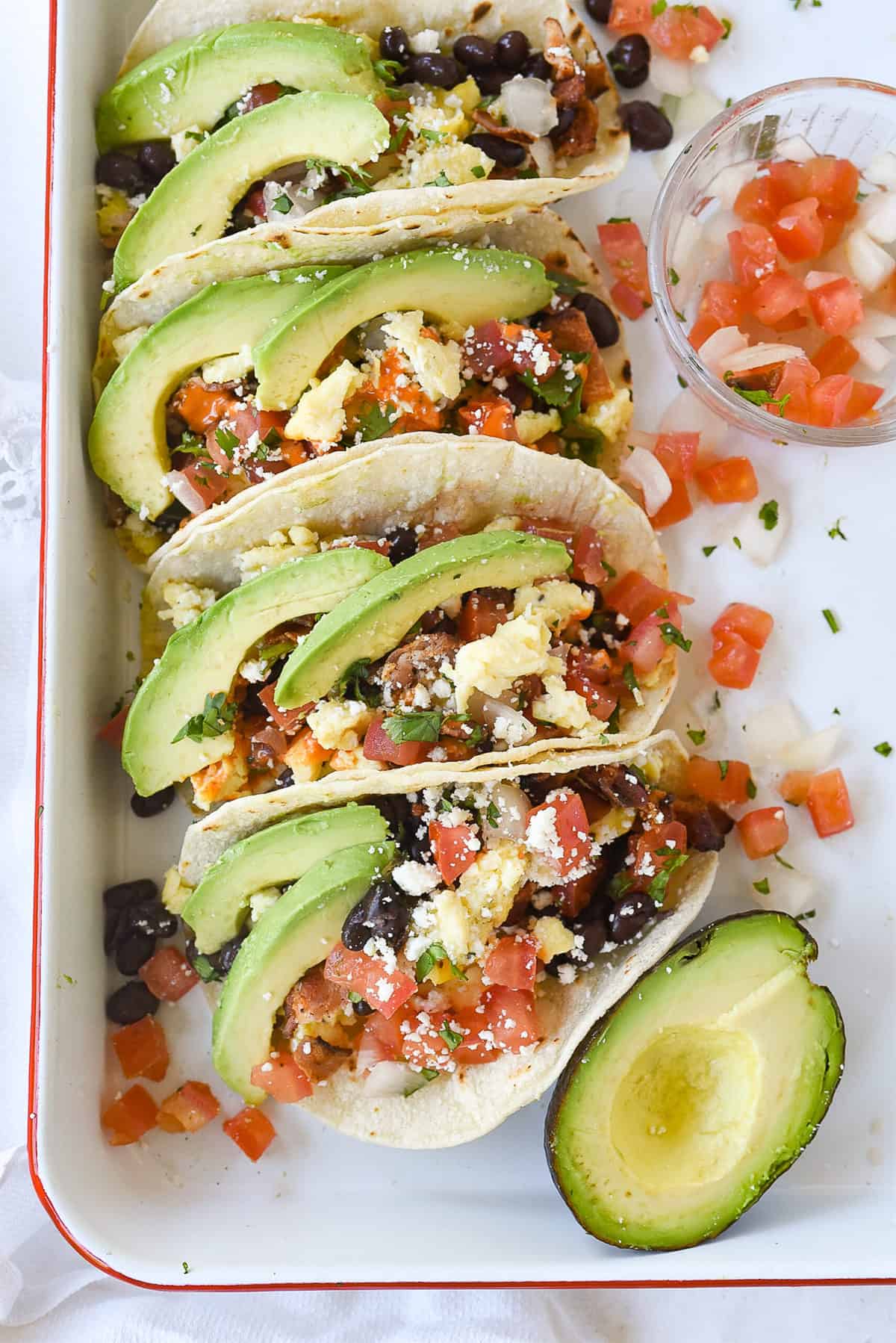 breakfast tacos on a white sheet pan