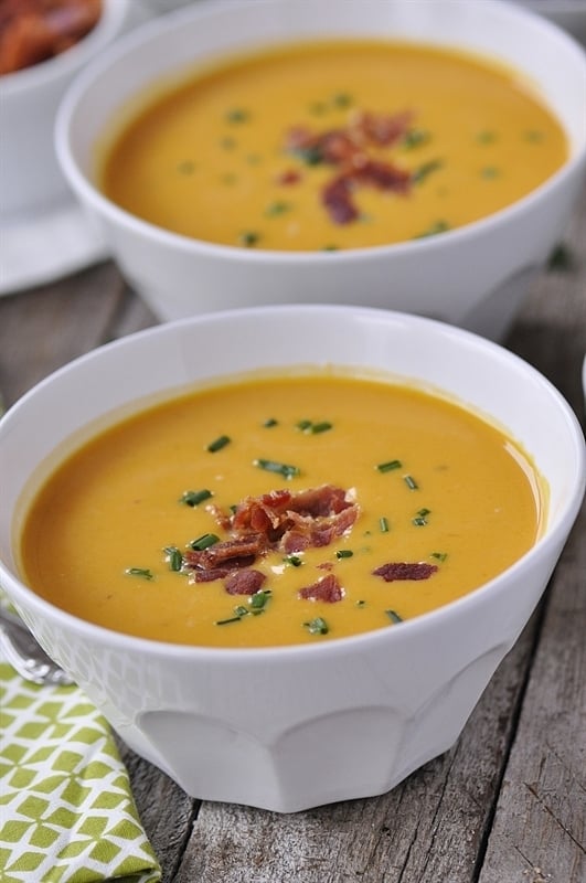 bowl of butternut squash soup topped with bacon and chives