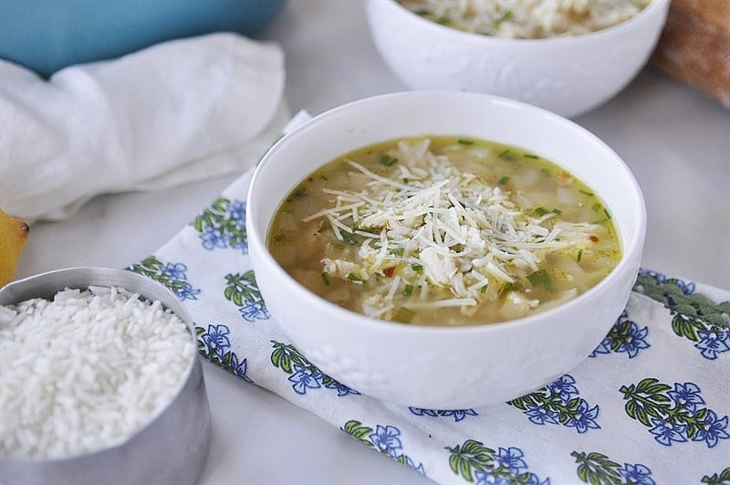 warm bowl of lemon chicken and rice soup topped with freshly grated Parmesan