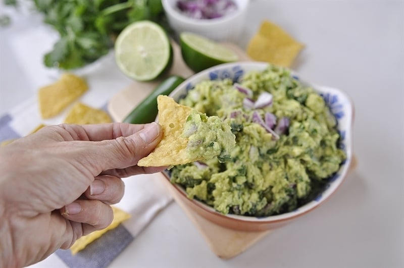 copycat chipotle guacamole eating guacamole on a chip