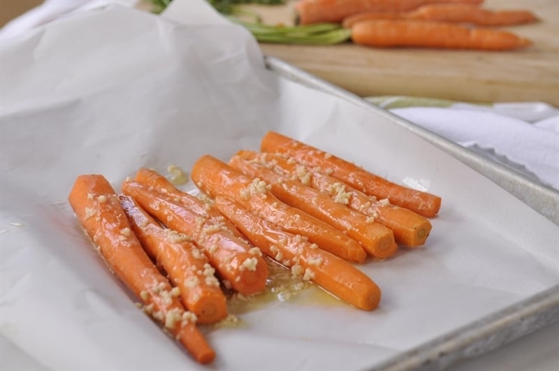 peeled arrots drizzled with garlic butter