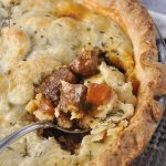 beef pot pie with a spoon in it