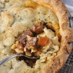 beef pot pie with a spoon in it
