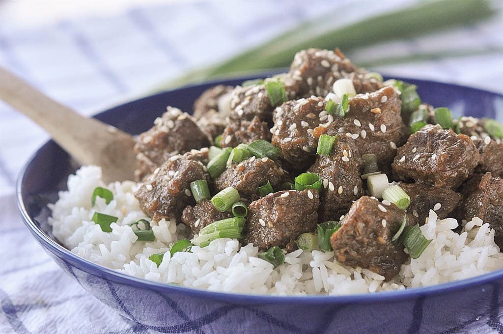 slow cooker teriyaki beef with scallions and sesame seeds