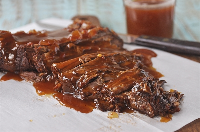 sliced brisket covered in sweet and sour sauce