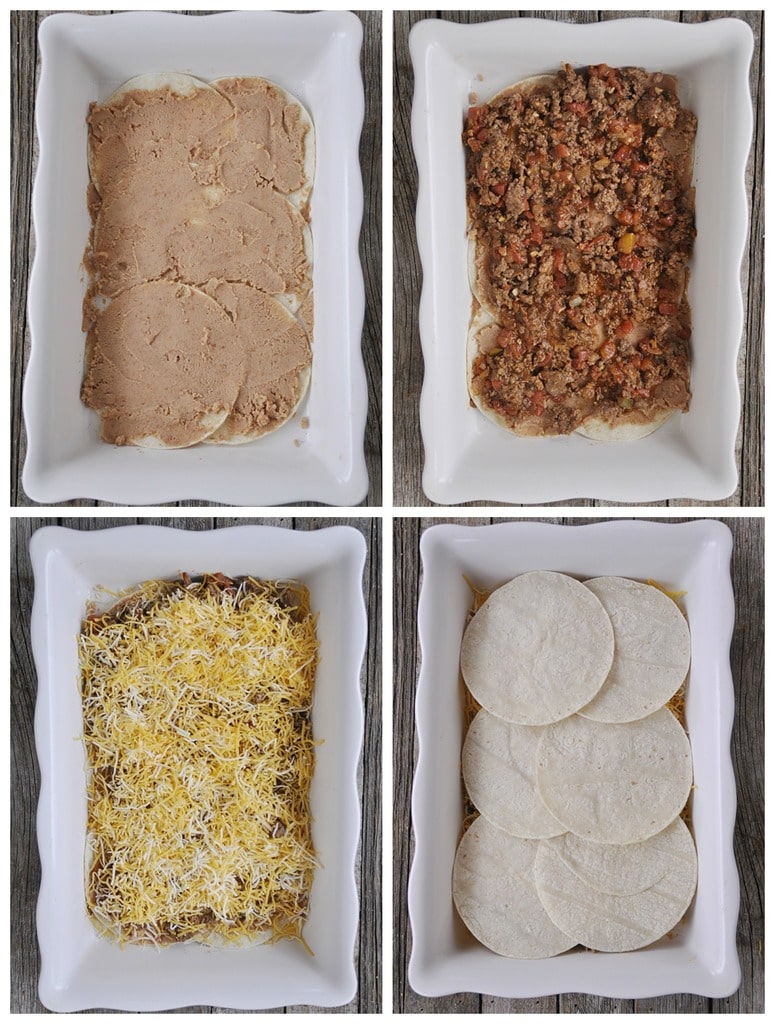 corn tortillas refried beans taco meat and cheese layered in a white casserole dish