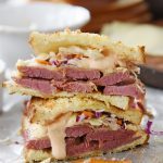 two pieces of reuben sandwich piled up
