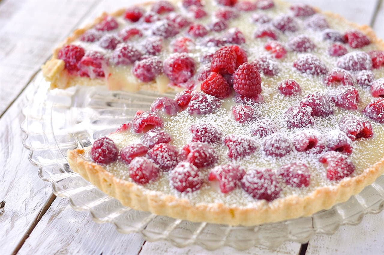 raspberry tart with piece missing