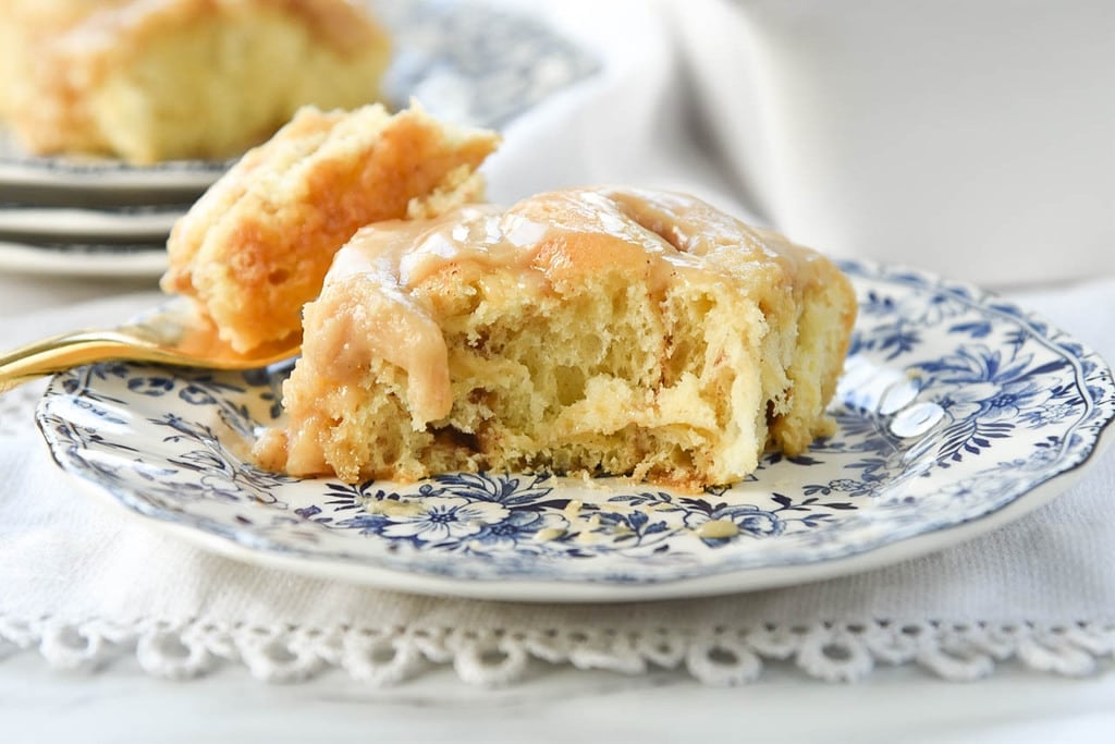 cinnamon roll on a plate with a bite missing
