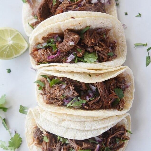 shredded beef tacos on a plate