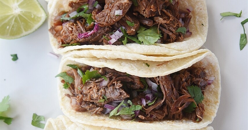 shredded beef tacos on a plate