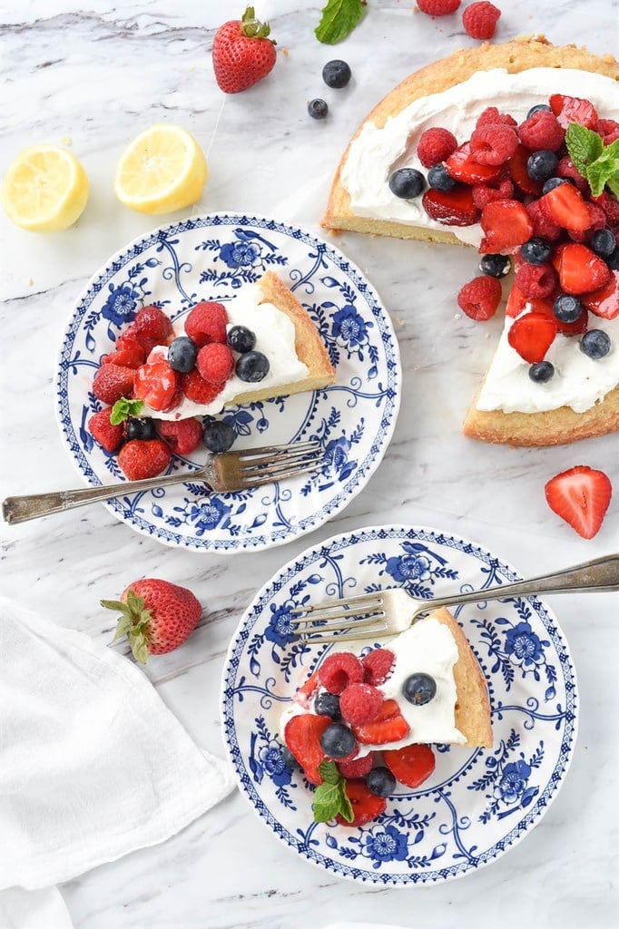 two slices of lemon pound cake with whipped cream and fresh berries