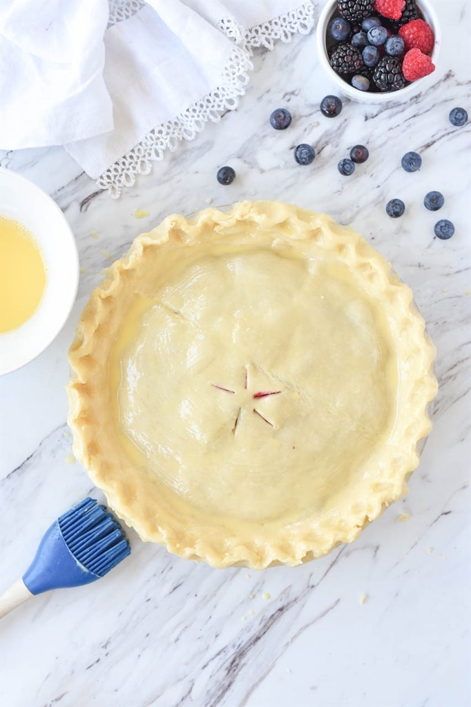 Brushing egg wash on pie crust