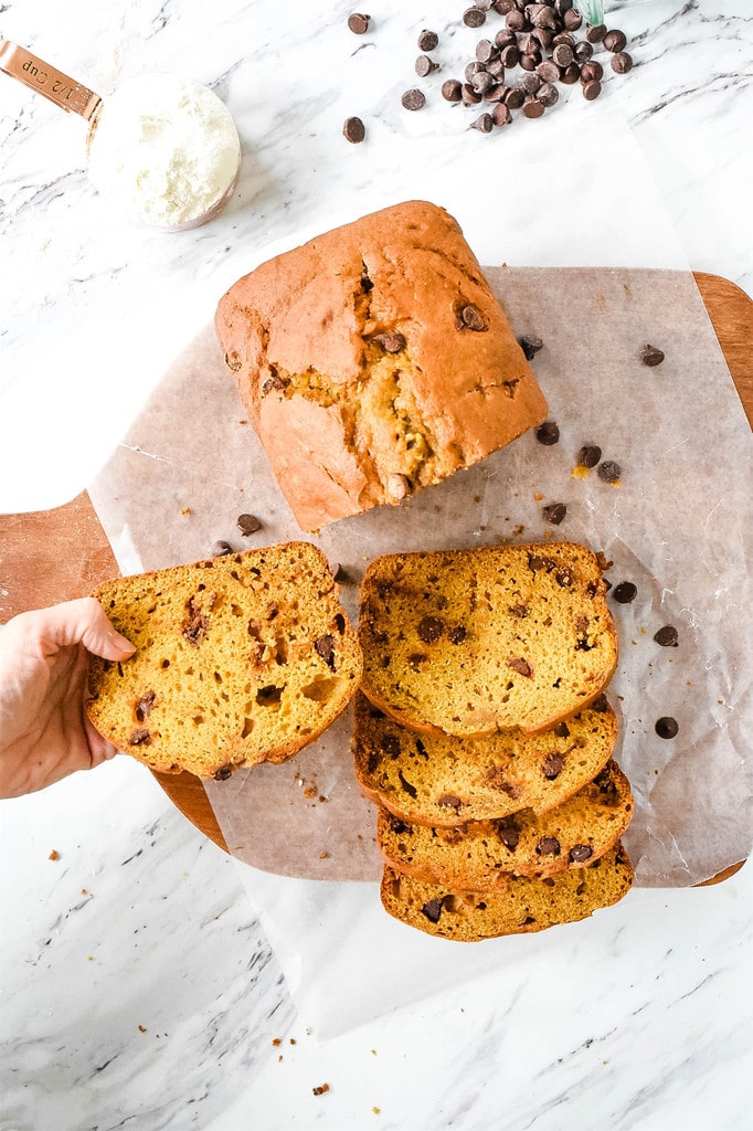 picking up a piece of pumpkin bread with chocolate chips