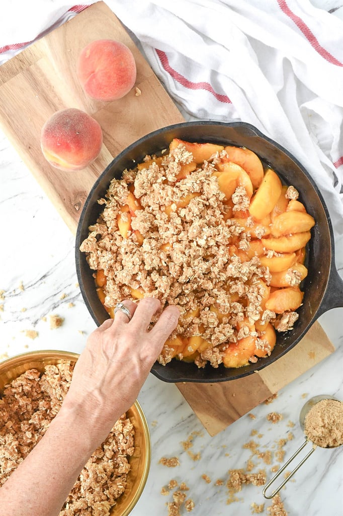 adding crumble to cast iron peach crips