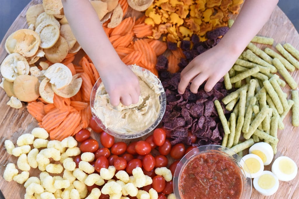 kids hands grabbing healthy snack food