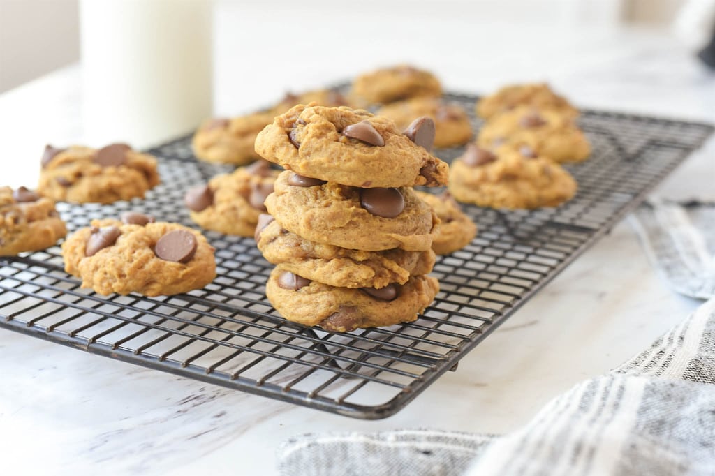 Pumpkin Chocolate Chip Cookies stacked on a cooling rack