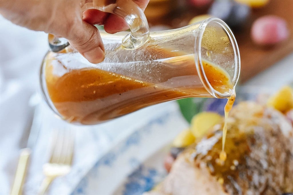 pouring maple glaze over Instant Pot Pork Roast