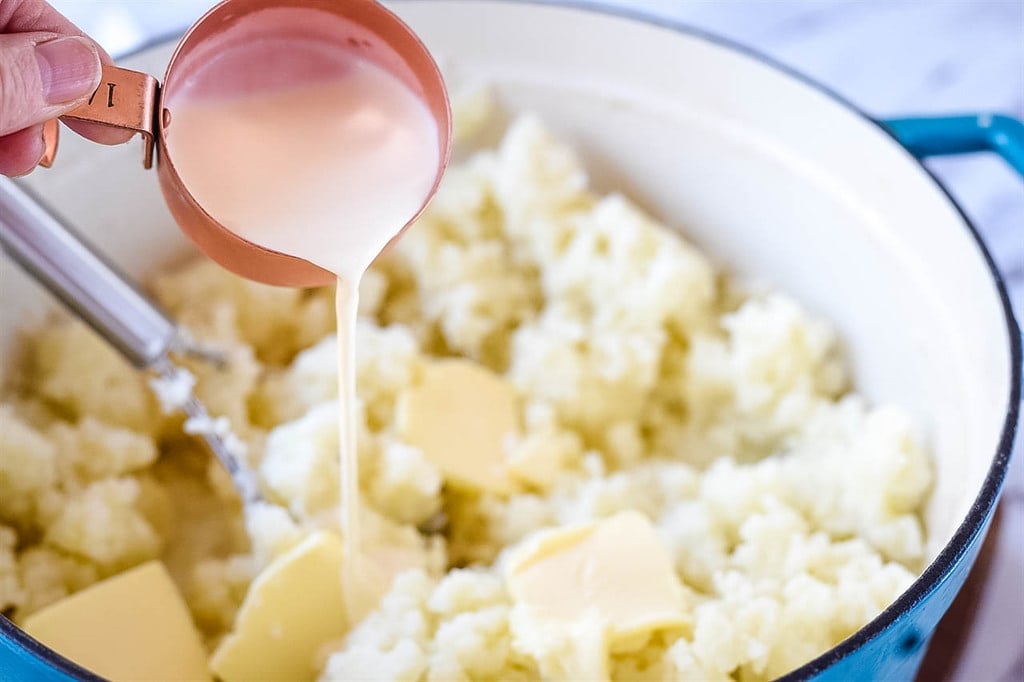 pouring cream in mashed potatoes