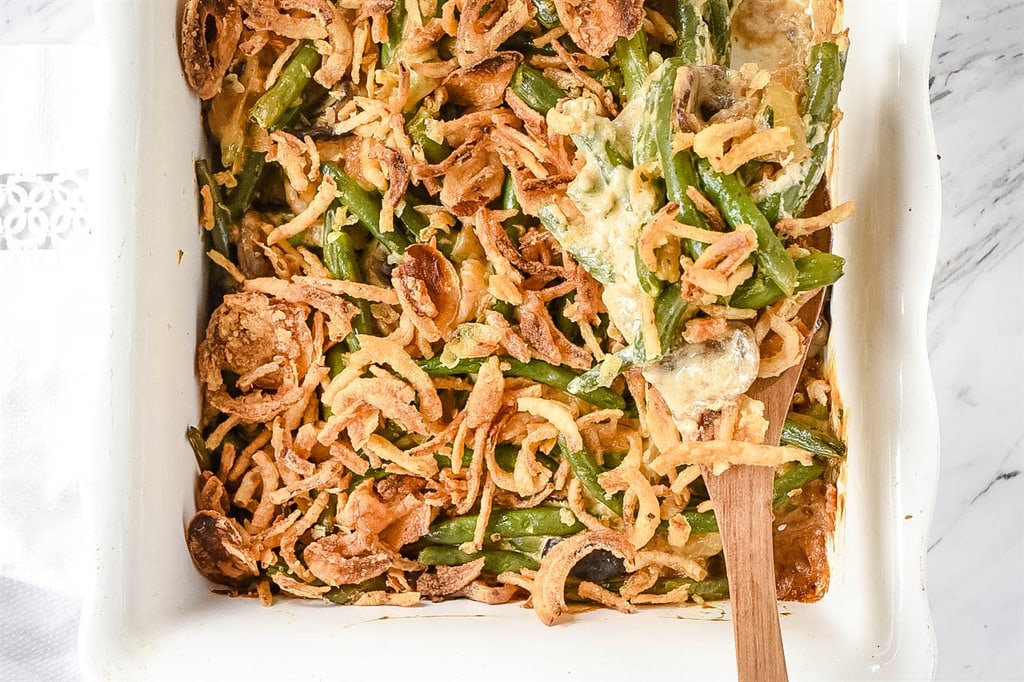 Green Bean Casserole with a wooden spoon in it