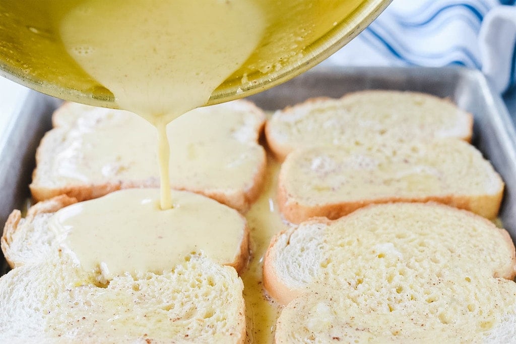 pouring egg mixture over french toast