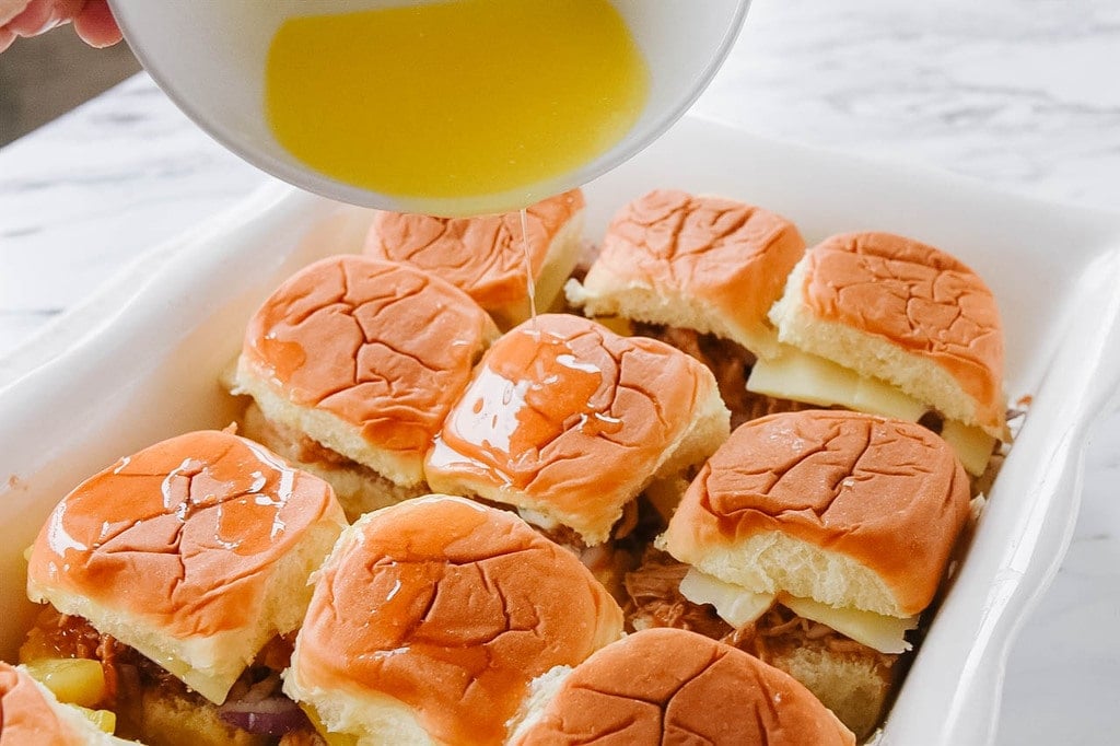 Pouring butter over Hawaiian Chicken Sliders