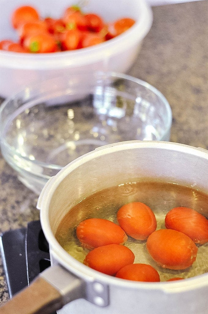 Tomatoes in a pot of water