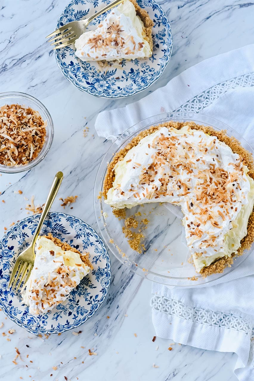 overhead shot of two pieces of coconut cream pie