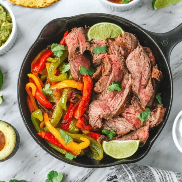 beef fajitas in a cast iron pan