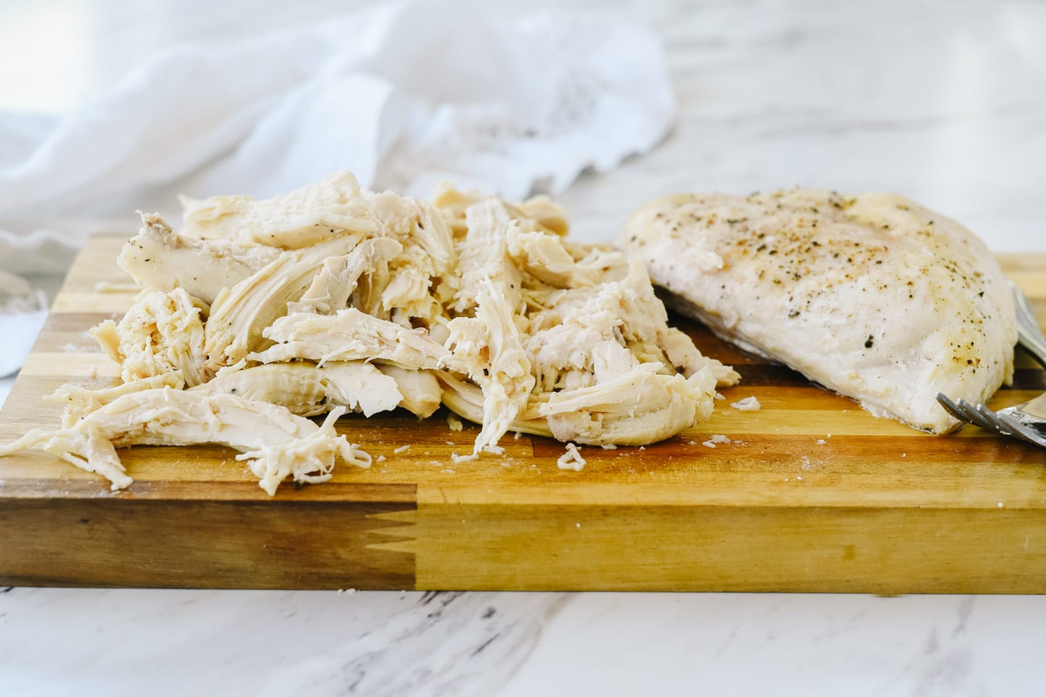 how to cook chicken in the microwave shredded chicken on a cutting board