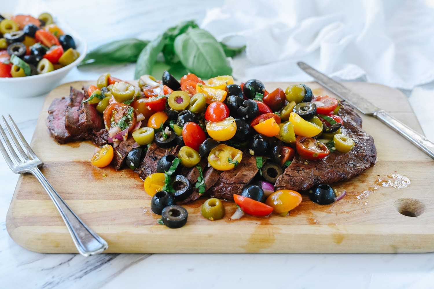 sliced flank steak on cutting board