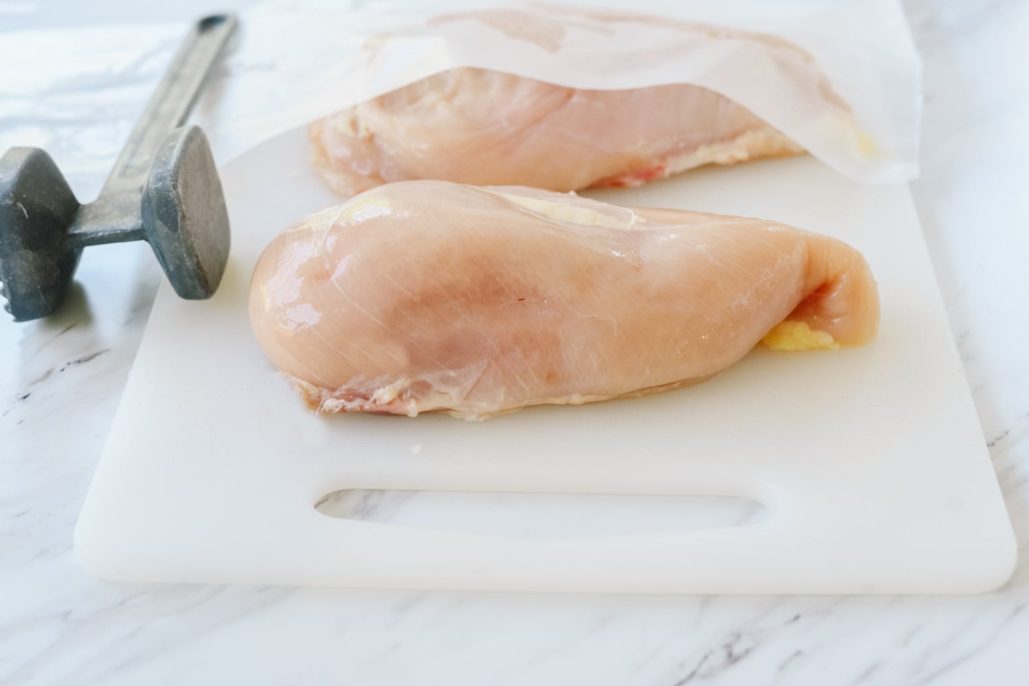 chicken breasts on cutting board