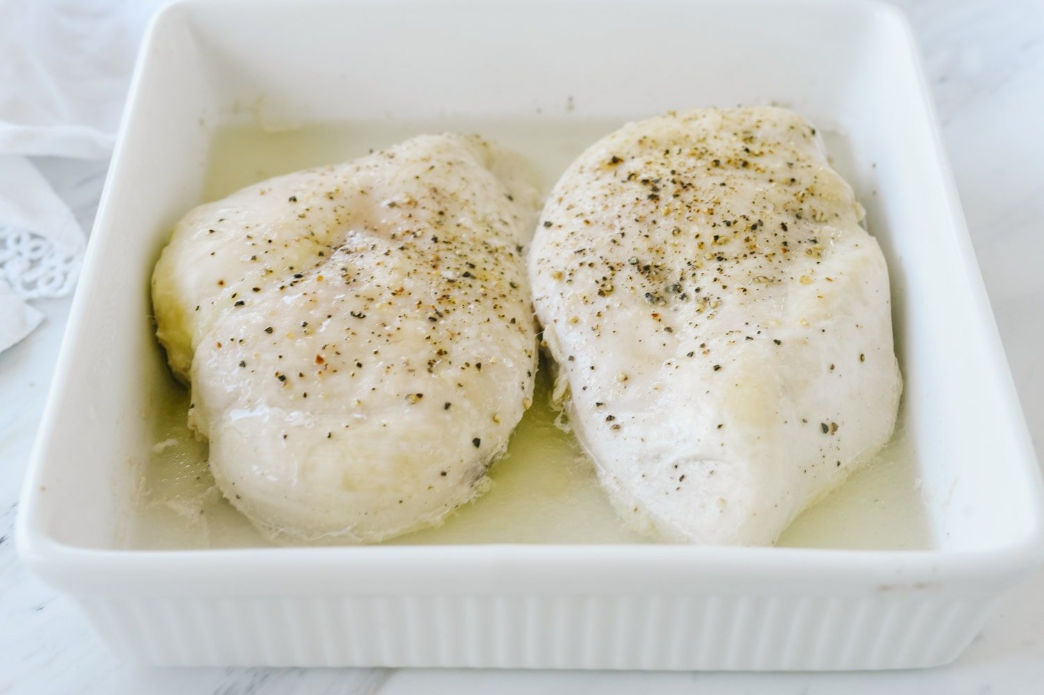 Two chicken breasts in a dish