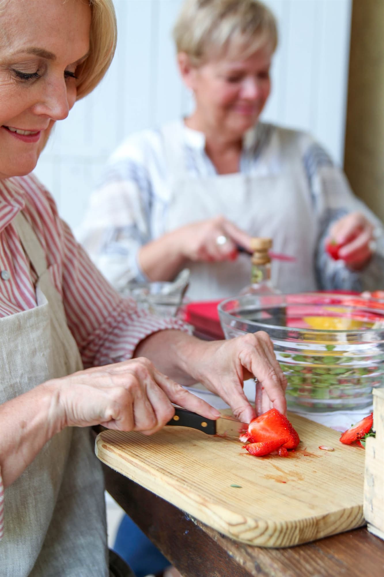 Cutting up strawberries for homemade strawberry jam