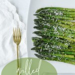 grilled asparagus on a plate with a fork