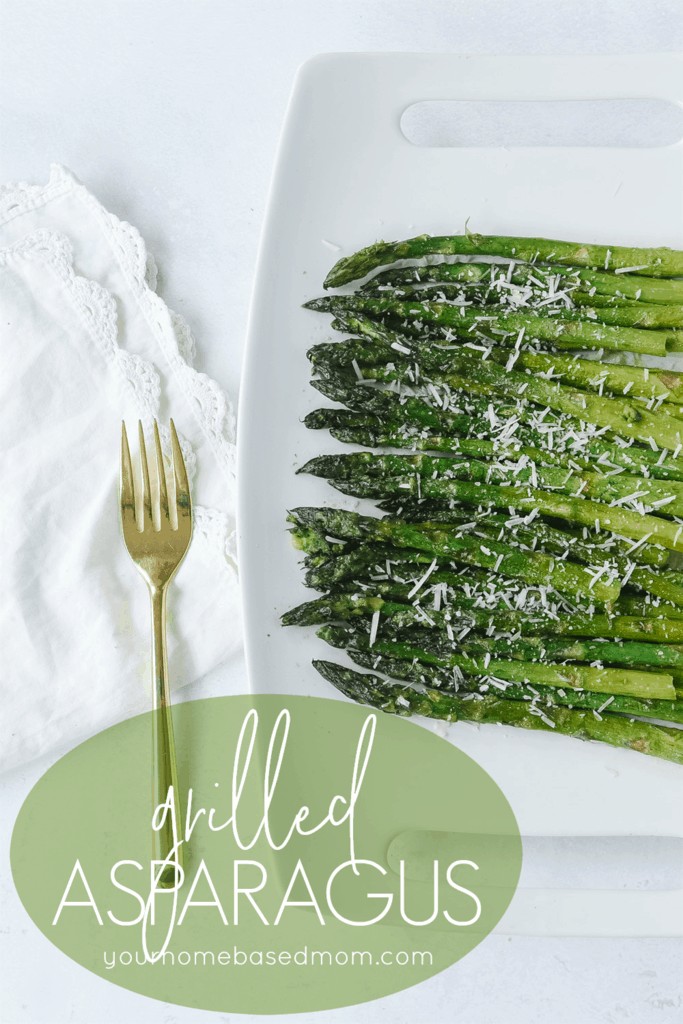 grilled asparagus on a plate with a fork