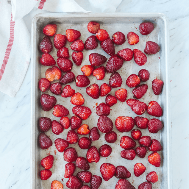 frozen strawberries on a baking sheet