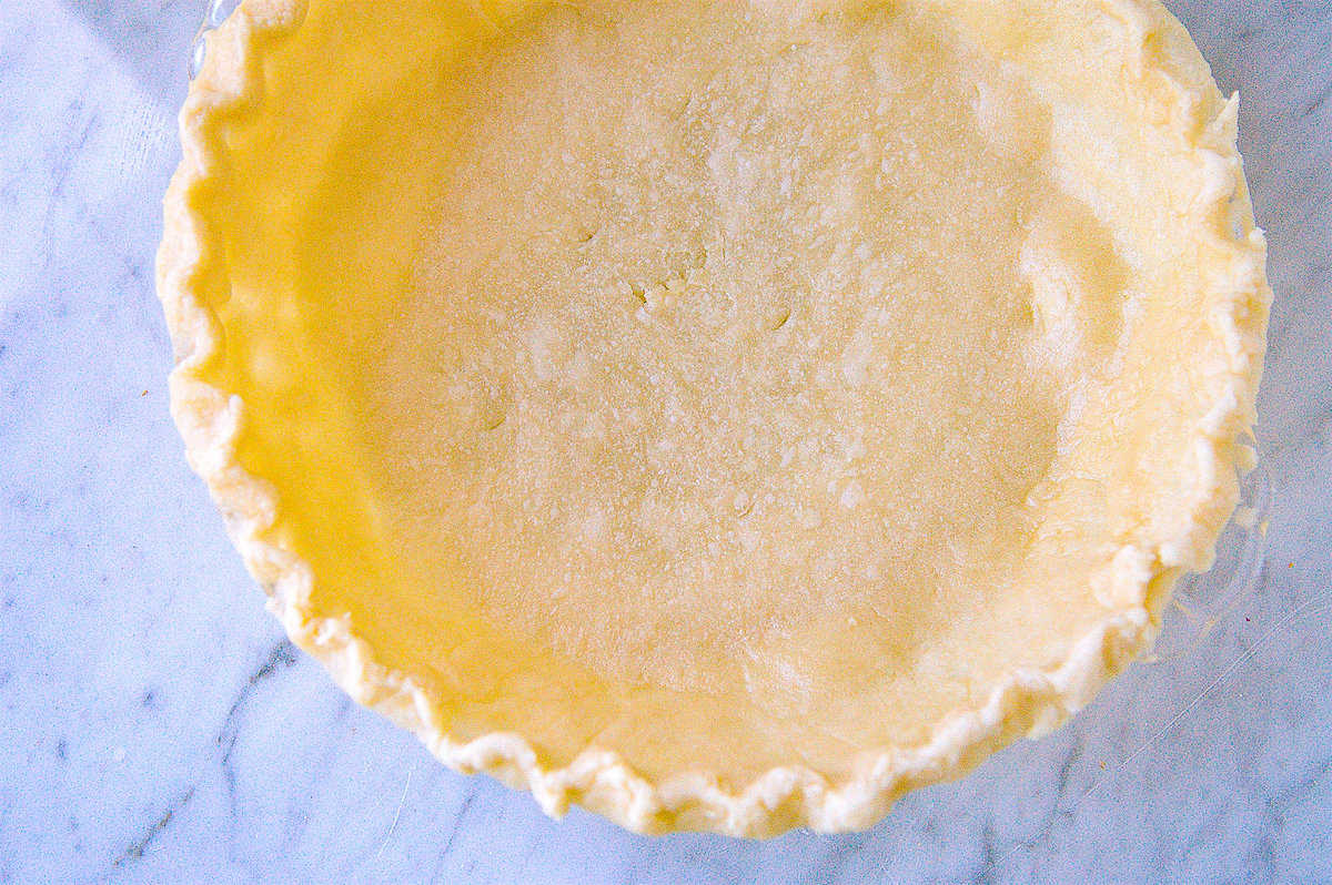 pie crust in a pie dish waiting to be baked