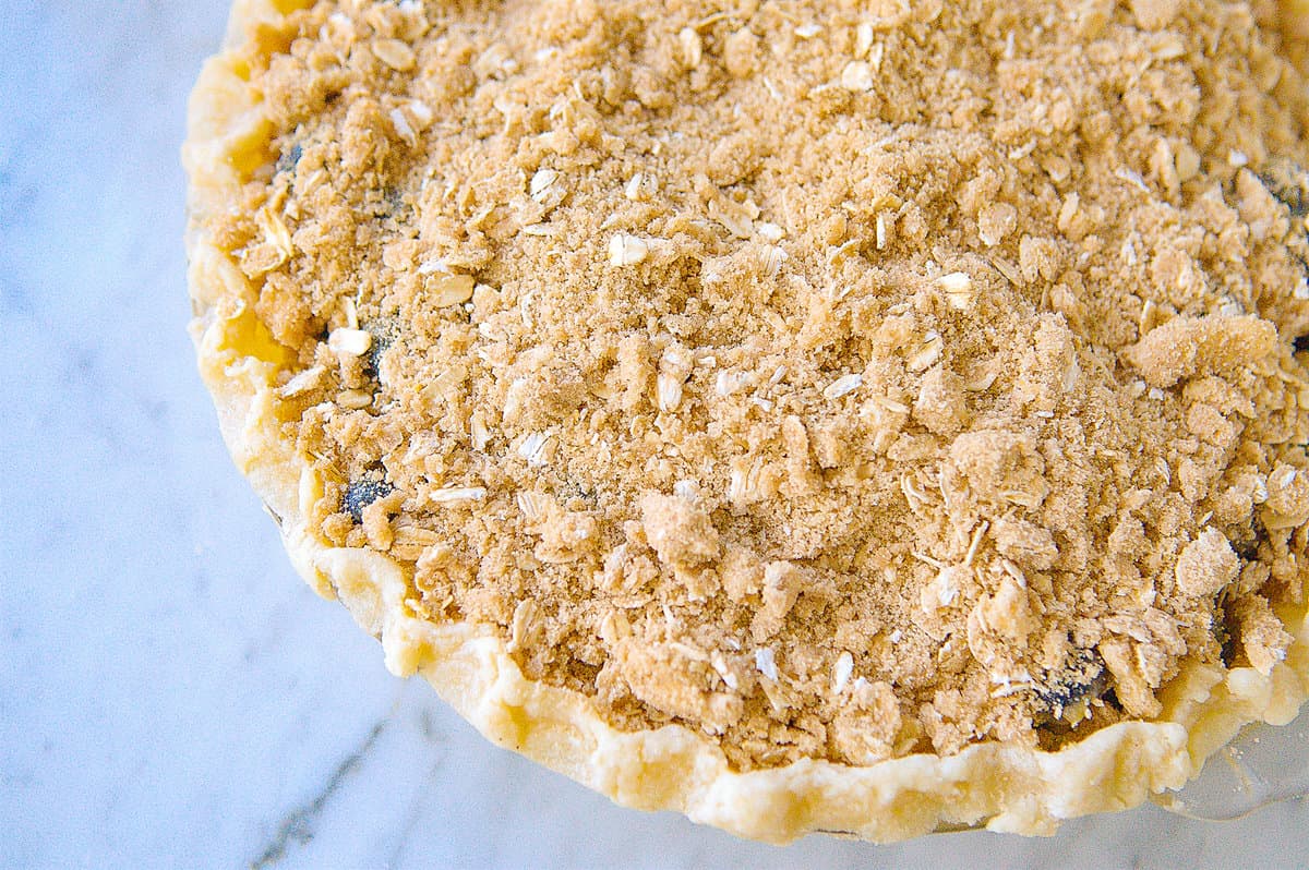 streusel topping on top of unbaked blueberry pie