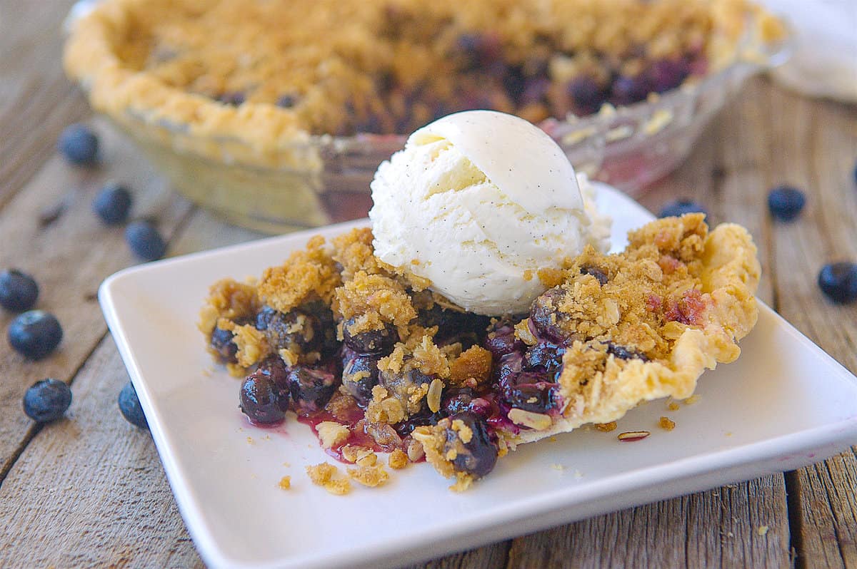 slice of blueberry pie with ice cream on top