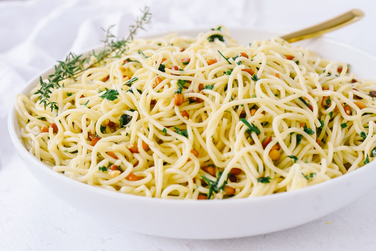 Herb Pasta in a white bowl with a fork