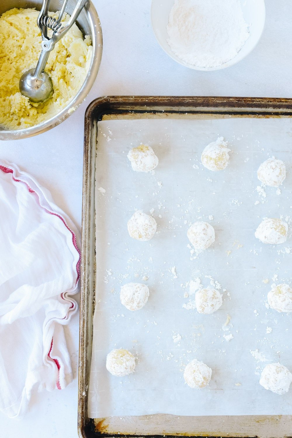 Lemon Crinkle dough balls on a baking sheet