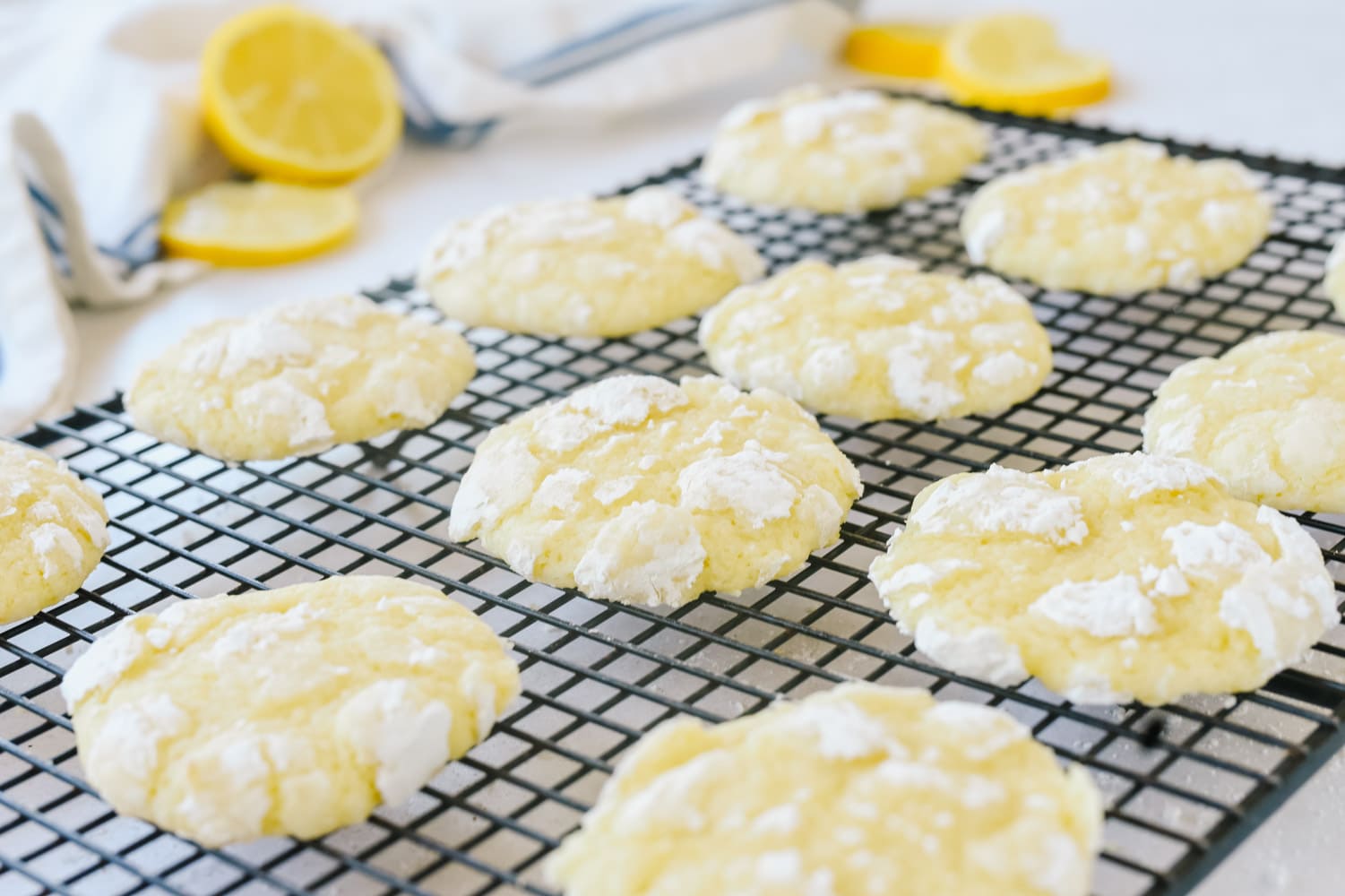 Lemon Crinkle cookies on a cooling rack